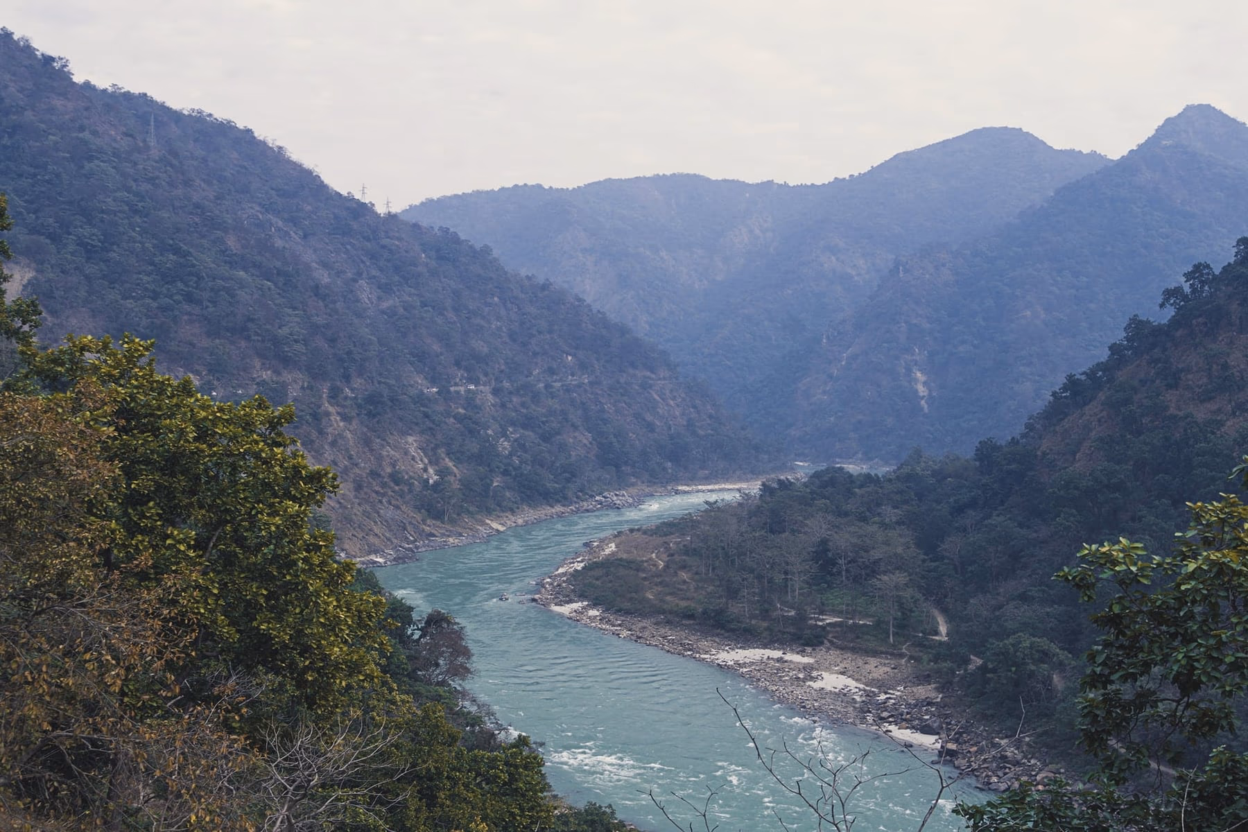 The Ganges flowing through a forested gorge in the Himalayan foothills of Uttarakhand